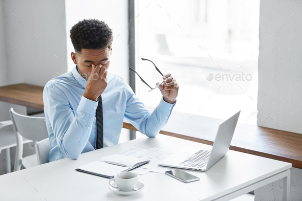 Stress, fatigue overwork. Tired African American employee in formal wear holding eyeglasses, rubbing