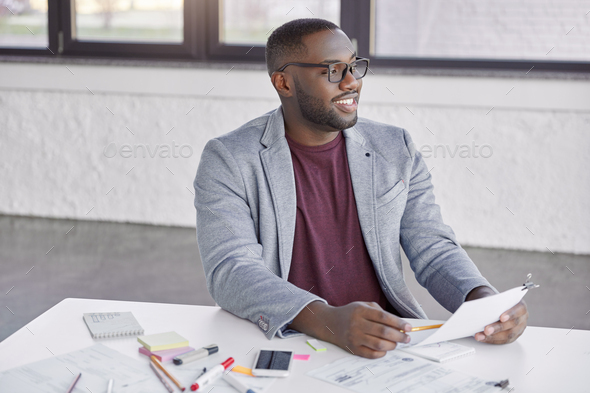 Happy successful dark skinned managing diractor of prosperous company glad to recieve high turnover, - Stock Photo - Images