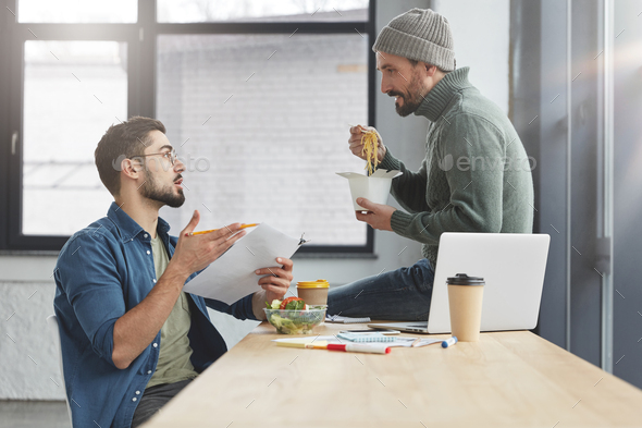 Portrait of friends or business partners discuss together new startup, have lunch break, sit over of