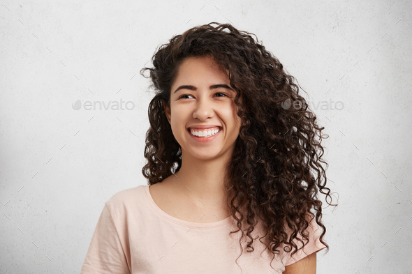 Beautiful Female With Curly Bushy Hair Mixed Nationality Dressed Casually Smiles Broadly