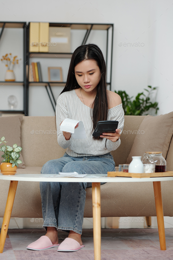 Young woman calculating expenses