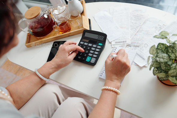 Woman calculating monthly expenses