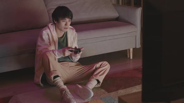 Asian Man Losing in Video Game alt