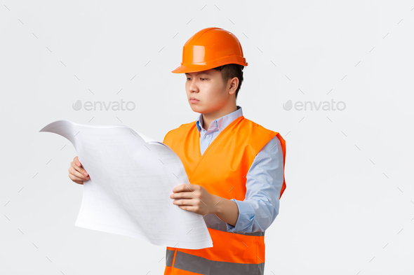 Building sector and industrial workers concept. Serious-looking asian construction manager