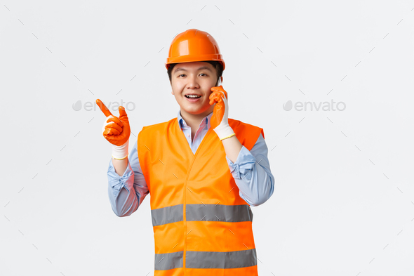 Building sector and industrial workers concept. Smiling asian engineer, construction manager in