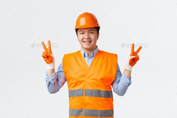 Building sector and industrial workers concept. Cute cheerful asian construction manager, engineer