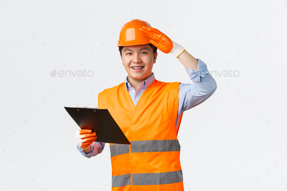 Building sector and industrial workers concept. Cheerful smiling asian construction manager
