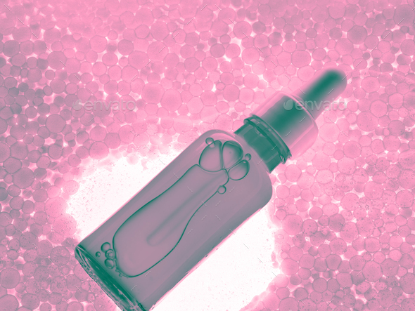 Hyaluronic acid serum generic bottle on pink bubble abstract background.