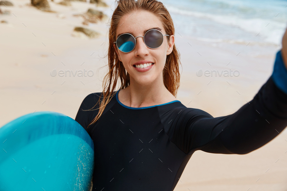 Free Photos - An Attractive Woman Wearing Sunglasses, A Red Shirt, And  Standing In Front Of Several Buildings. Her Style Gives Off A Fashionable  And Confident Vibe As She Poses For The