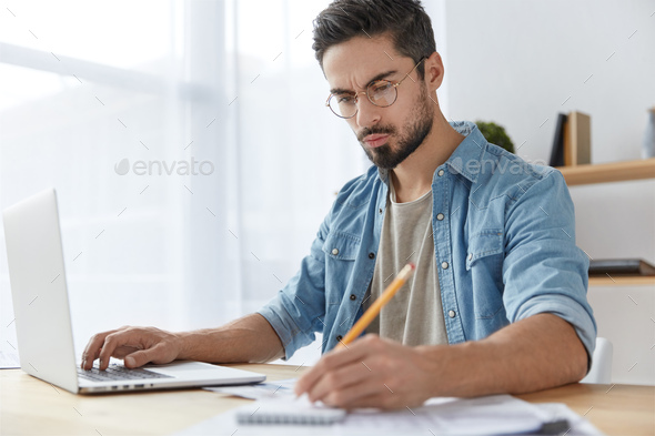 Experienced CEO reads news, searches information on websites and writes down notes in diary, has ser
