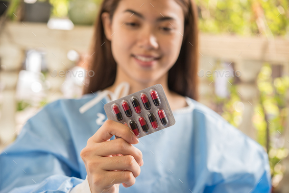 Woman pharmacist holding prescription medicine from doctor order