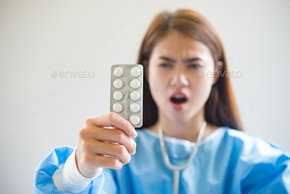 Woman pharmacist holding prescription medicine from doctor order