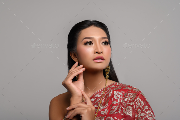 Women wearing Thai clothes and hands touching their faces - Stock Photo - Images