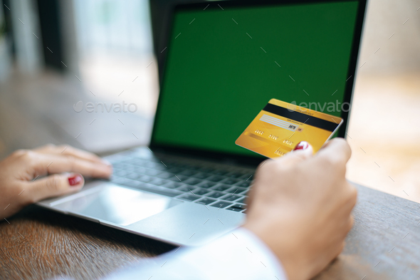 woman sat with a laptop and paid with a credit card - Stock Photo - Images