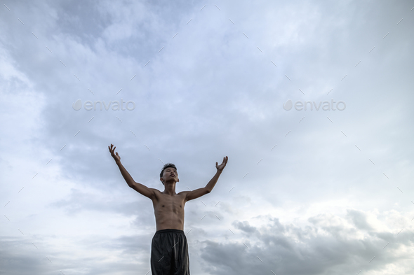 The boy raised his hand to the sky to ask for rain,Global warming and water crisis