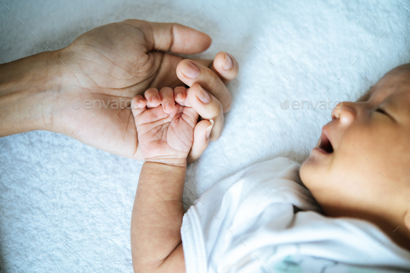 Download The Newborn Baby Sleeping And Puts The Hand On The Mother S Hand Stock Photo By Johnstocker