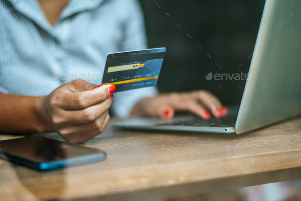 woman sat with a laptop and paid with a credit card - Stock Photo - Images