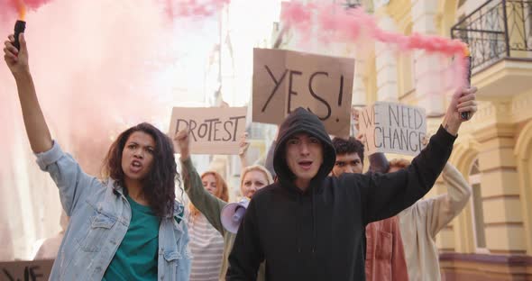 Angry Activists Protesters Protesting in the City with Posters Smoke Bombs and Fire Flares alt