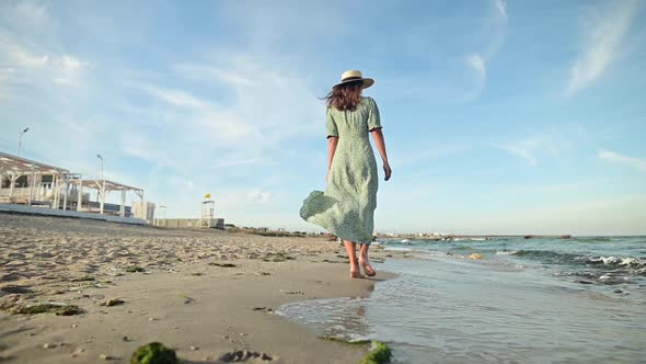 Attractive Woman in Slow Motion Walking Barefoot Along the Beach in the Early Morning alt