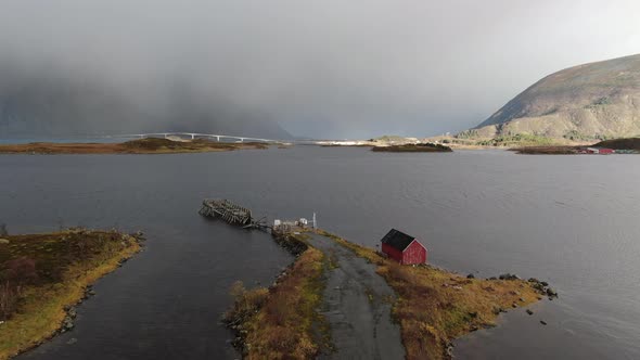 Drone Over Hut With Rainbow Over Fjord alt