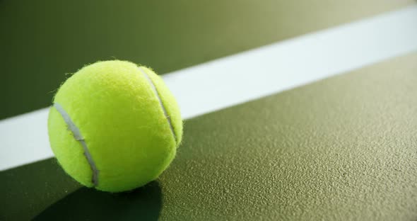 Close-up of tennis ball near white line alt