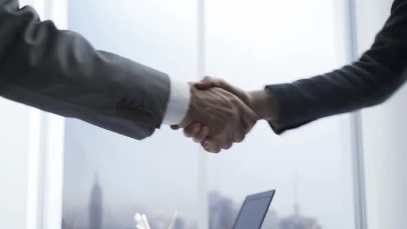 Customer signing a contract and shaking hands