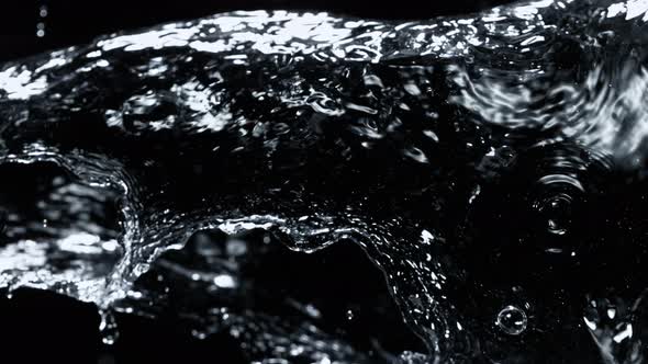 Super Slow Motion Detail Shot of Water Stream Isolated on Black Background at 1000Fps alt
