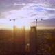Aerial view of a multi-storey building under construction with construction cranes at sunset - VideoHive Item for Sale