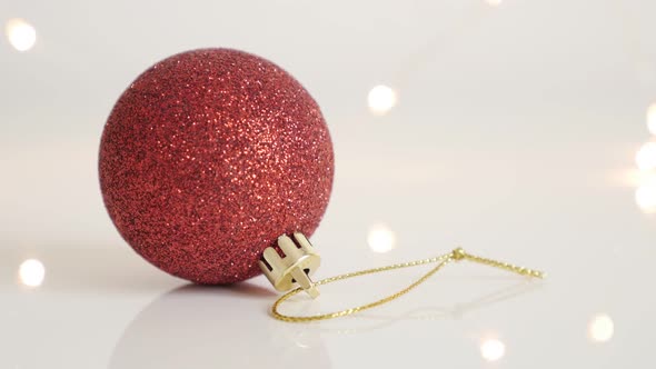 Tilting on bauble with sequins close-up 4K 2160p 30fps UltraHD footage - Red Christmas ornament and  alt