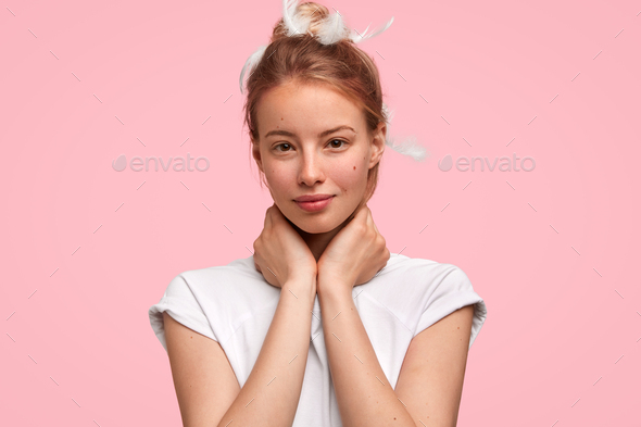 Headshot Of Beautiful European Female With Healthy Skin Keeps Hands On Neck Has Feathers On 9213