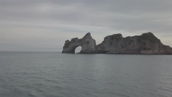 Rock with archway in the ocean