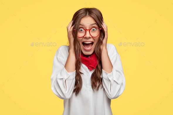 Glad woman cannot believe she is rich, screams from surprise and positive emotions, feels surprised,