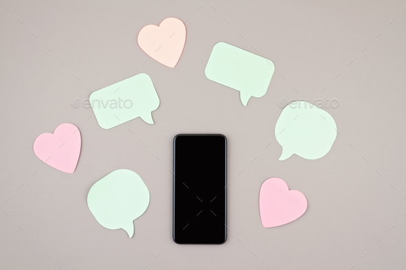 Mockup flat lay with smartphone and hearts and speach bubbles