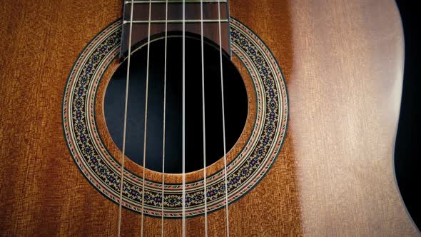 Passing Acoustic Guitar Strings Closeup alt