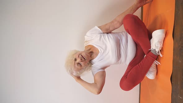 an Elderly Lady Does Gymnastics Yoga and Meditation at Home During the Coronavirus Pandemic