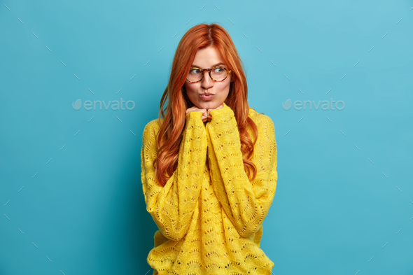 Portrait Of Lovely Redhead European Woman Keeps Hands Under Chin And Lips Rounded Dreams About 2543