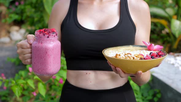Closeup of Sport Woman with Healthy Diet Fruit Smoothie Bowl with Oatmeal alt