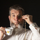 Man with muttonchops and funny expression holding monacle and cup of tea. - PhotoDune Item for Sale