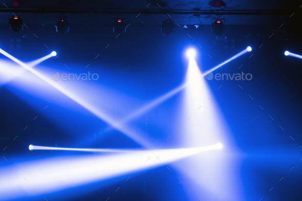 Abstract blurred photo of spotlight on the stage in conference hall or nightclub,