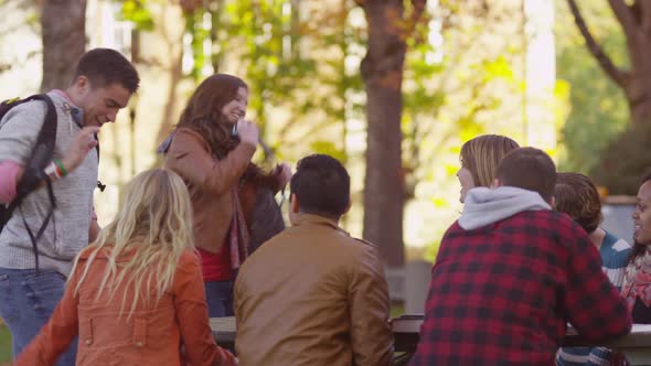 Group of college students on campus meeting outdoors