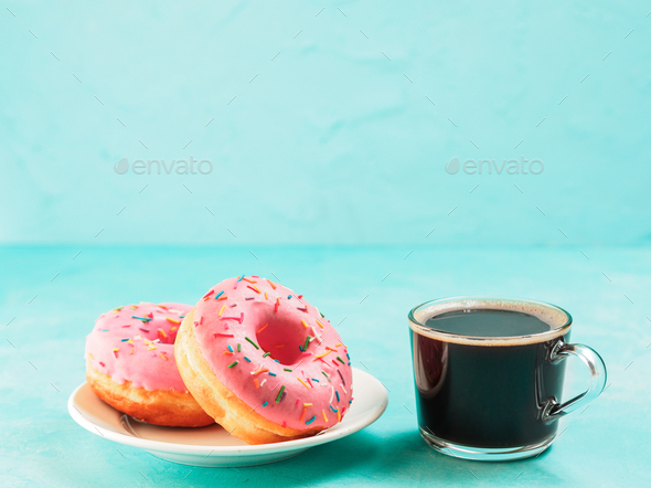 pink donuts on blue background , copy space - Stock Photo - Images