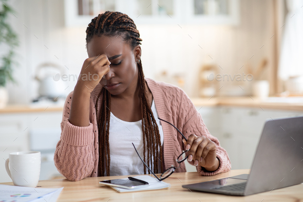 Eyes Strain. Overworked Black Freelancer Woman Tired After Using Laptop In Kitchen