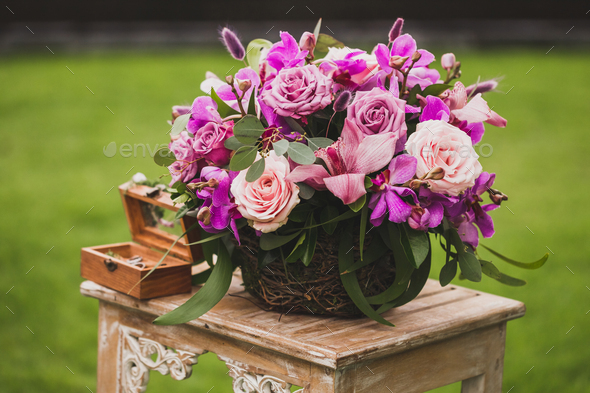 Wedding decorations Boho style with pink and purple orchids, roses, ivy and grape