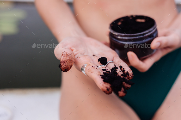 Outdoor shot of woman with coffee body scrub