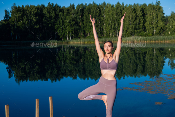 Faceless woman performing Tree with Arms Up pose against sea - a Royalty  Free Stock Photo from Photocase