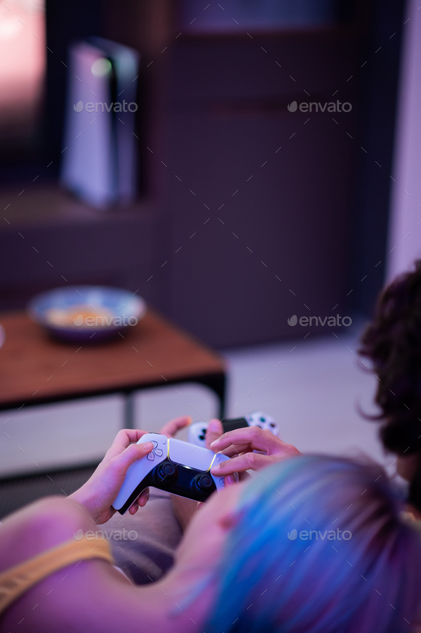 Girl with next gen controller in her hands playing games at home - Stock Photo - Images