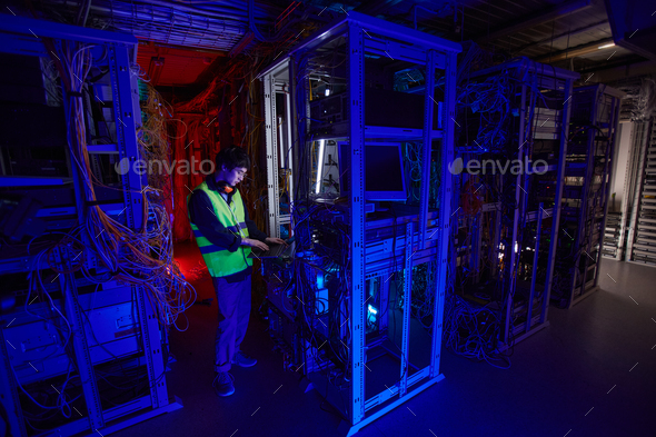IT Technician Inspecting Server Room