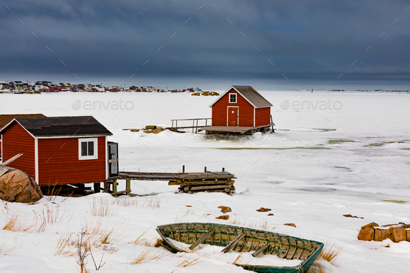 Shacks at frozen shore of Joe Batts Arm NL Canada - Stock Photo - Images