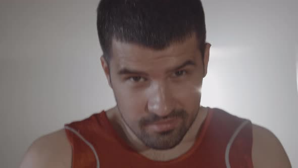 Brunette Cheerful Sportsman Raising Head and Looking at Camera. Close-up Portrait of Smiling Young alt