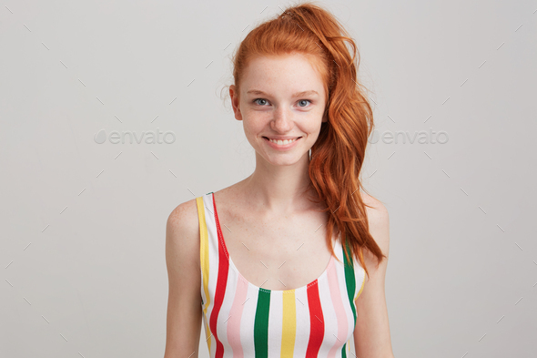 redhead young woman with freckles and ponytail wears striped top Stock  Photo by nakaridore